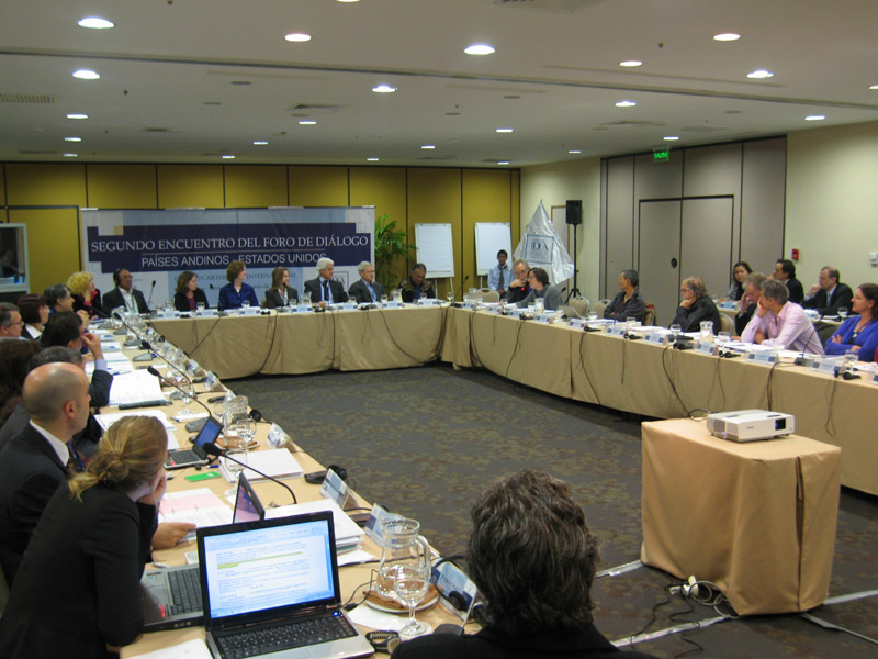 Participants sitting at a u-formation conference table.