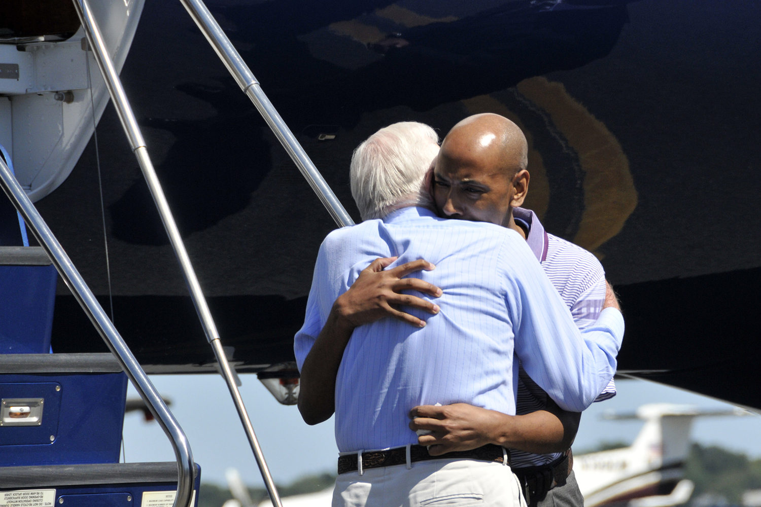 Aijalon Gomes embraces Jimmy Carter.