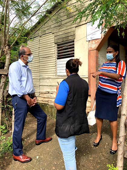 Photo of Kashef Ijaz listening to a community health worker.