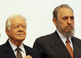 President Carter listens to the U.S. national anthem during the arrival ceremony of his historic visit to Cuba in May 2002 at the invitation of Fidel Castro.