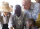 Rosalynn Carter watches as a Guinea worm health worker dresses a child's extremely painful Guinea worm wound.