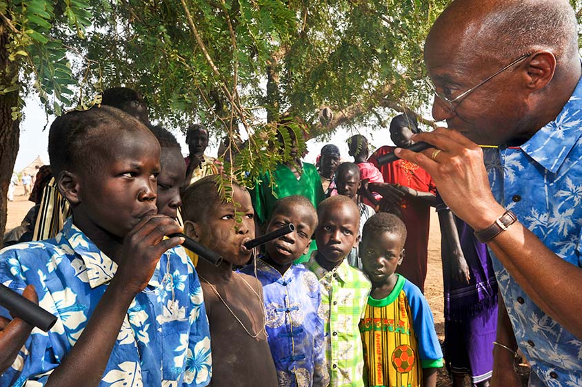 Dr. Donald Hopkins demonstrates how to use a pipe filter to prevent Guinea worm disease in Molujore, South Sudan.